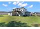 Backyard of the home featuring green lawn and a wooden deck at 11780 Linden Dr, Spring Hill, FL 34608