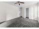 Cozy bedroom with soft carpet, ceiling fan, closet, and a window for natural light at 11780 Linden Dr, Spring Hill, FL 34608