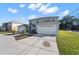 Two-story home featuring a driveway leading to attached two-car garages and manicured landscaping at 11780 Linden Dr, Spring Hill, FL 34608