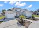 Charming two-story home with attached two-car garage and well-maintained landscaping on a sunny day at 11780 Linden Dr, Spring Hill, FL 34608