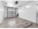 Spacious garage with concrete floor, white walls and garage door with window openings at 11780 Linden Dr, Spring Hill, FL 34608