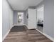 Open hallway with laminate floors providing access to the kitchen, office, and bedroom at 11780 Linden Dr, Spring Hill, FL 34608