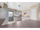 Well-lit kitchen featuring tiled floors, white appliances, and plenty of countertop space for food preparation at 11780 Linden Dr, Spring Hill, FL 34608
