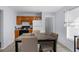 Bright kitchenette with adjacent cooking area with black stovetop, white cabinets, and table at 11780 Linden Dr, Spring Hill, FL 34608