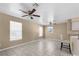 Bright living room with tiled flooring, ceiling fans, and natural light from multiple windows at 11780 Linden Dr, Spring Hill, FL 34608