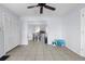 Spacious living room with tile floors and direct access to dining area and a view of the kitchen at 11780 Linden Dr, Spring Hill, FL 34608