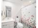 Bright bathroom featuring a shower with a floral curtain at 12264 Grizzly Ln, New Port Richey, FL 34654
