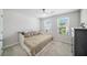 Sunlit bedroom with neutral tones, plush carpet, and built-in storage at 12264 Grizzly Ln, New Port Richey, FL 34654