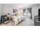 Comfortable bedroom with a ceiling fan, window with curtains, and decorative pillows at 12264 Grizzly Ln, New Port Richey, FL 34654