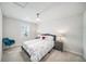 Cozy bedroom with a ceiling fan and a bed with decorative pillows at 12264 Grizzly Ln, New Port Richey, FL 34654