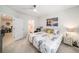 Nicely decorated bedroom with a ceiling fan and a doorway leading to the bathroom at 12264 Grizzly Ln, New Port Richey, FL 34654