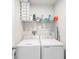 Practical laundry room with a stacked washer and dryer and shelving for supplies at 12264 Grizzly Ln, New Port Richey, FL 34654