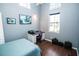 Bedroom featuring hardwood floors, an open window, and a workspace with a printer and a desk at 1257 Lyndhurst Greens Dr, Sun City Center, FL 33573