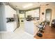 Spacious kitchen with white cabinets, tile flooring, stainless-steel appliances, and a breakfast bar at 1257 Lyndhurst Greens Dr, Sun City Center, FL 33573