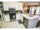 Well-equipped kitchen featuring stainless steel appliances, white cabinetry, and plenty of counter space at 1257 Lyndhurst Greens Dr, Sun City Center, FL 33573