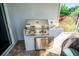 Close-up of outdoor kitchen with stainless steel grill, tile backsplash and storage at 1257 Lyndhurst Greens Dr, Sun City Center, FL 33573