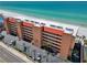 Discover stunning views of this beachfront condominium with a red roof, surrounded by lush landscaping at 13720 Gulf Blvd # 305, Madeira Beach, FL 33708