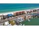 An aerial view showcases the coastal condo's prime location, steps away from the beach, shops, and restaurants at 13720 Gulf Blvd # 305, Madeira Beach, FL 33708