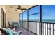 Enjoy breathtaking ocean views from the condo's spacious, screened-in balcony with dining set and comfortable chairs at 13720 Gulf Blvd # 305, Madeira Beach, FL 33708