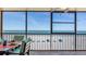 Relax on the screened-in balcony with dining space, offering stunning views of the beach and ocean at 13720 Gulf Blvd # 305, Madeira Beach, FL 33708