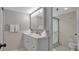 Fresh bathroom with double vanity, framed mirror, walk in shower and clean design at 13720 Gulf Blvd # 305, Madeira Beach, FL 33708