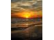 Beautiful sunset over the ocean with birds flying in the distance on the beach at 13720 Gulf Blvd # 305, Madeira Beach, FL 33708