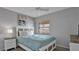 Bedroom with ceiling fan, a cozy bed, window views, and bedside lamp at 13720 Gulf Blvd # 305, Madeira Beach, FL 33708