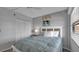 Bedroom features a cozy bed, white closet doors and ceiling fan at 13720 Gulf Blvd # 305, Madeira Beach, FL 33708