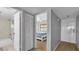 Hallway with view to bath and bedroom with ceiling fan and carpet at 13720 Gulf Blvd # 305, Madeira Beach, FL 33708