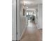 Hallway view leading to living area with ocean views; neutral walls and hardwood flooring provide warmth at 13720 Gulf Blvd # 305, Madeira Beach, FL 33708