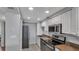 Updated kitchen features stainless steel appliances and plentiful white cabinets for ample storage space at 13720 Gulf Blvd # 305, Madeira Beach, FL 33708