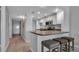 A compact kitchen with updated appliances and a breakfast bar with seating for casual dining at 13720 Gulf Blvd # 305, Madeira Beach, FL 33708