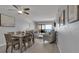 Open-concept living room with dining area and ocean views from sliding glass doors to a private balcony at 13720 Gulf Blvd # 305, Madeira Beach, FL 33708