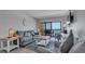 Bright living room with stylish furnishings and balcony access overlooking the ocean at 13720 Gulf Blvd # 305, Madeira Beach, FL 33708
