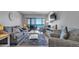 Charming living room with comfortable seating and ocean view balcony access creating an inviting atmosphere at 13720 Gulf Blvd # 305, Madeira Beach, FL 33708