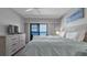 Comfortable king bed in bedroom with TV and ocean view balcony access for ultimate relaxation at 13720 Gulf Blvd # 305, Madeira Beach, FL 33708