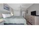 Calm bedroom offers a king-sized bed, TV, and ample closet space for organized living at 13720 Gulf Blvd # 305, Madeira Beach, FL 33708