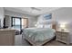 Relaxing bedroom with balcony access and ocean views, featuring a comfortable king-size bed and soothing decor at 13720 Gulf Blvd # 305, Madeira Beach, FL 33708