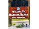 Welcome sign to Madeira Beach, Florida with lush landscaping at 13720 Gulf Blvd # 305, Madeira Beach, FL 33708