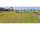 Lush green backyard with a well-maintained lawn that slopes down to the tranquil lake, creating a serene setting at 1604 Storington Ave, Brandon, FL 33511