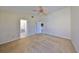 A bedroom featuring carpet, a fan, and open door to the bathroom at 1604 Storington Ave, Brandon, FL 33511