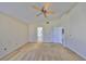 Spacious carpeted bedroom with ceiling fan, ensuite bathroom, and large walk in closet at 1604 Storington Ave, Brandon, FL 33511