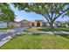Well-maintained single-story home featuring a spacious lawn, mature tree, and an attached two-car garage at 1604 Storington Ave, Brandon, FL 33511