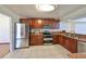 Bright kitchen with stainless steel appliances and dark wooden cabinets at 1604 Storington Ave, Brandon, FL 33511