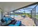 Screened in patio with comfortable seating overlooking a pool with lake views at 1604 Storington Ave, Brandon, FL 33511