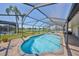 Inviting screened-in pool with clear water, brick patio, and a beautiful view of the lake beyond the screen at 1604 Storington Ave, Brandon, FL 33511