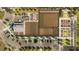An aerial view of the community farm showcases garden plots, a greenhouse, and parking at 17572 Happytrails St, Land O Lakes, FL 34638