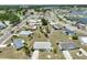 An aerial view shows the single-story home and surrounding neighborhood with mature landscaping at 1809 Haverford Ave, Sun City Center, FL 33573
