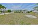 Single-story home featuring a well-manicured lawn, lush greenery, and attractive landscaping at 1809 Haverford Ave, Sun City Center, FL 33573