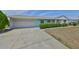 Home with an attached garage, complemented by a well-maintained lawn at 1809 Haverford Ave, Sun City Center, FL 33573